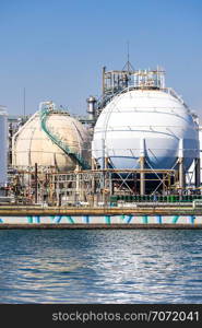 Chemical Factory plant with gas storage and structure of pipeline with smoke from smokestack in Kawasaki City near Tokyo Japan