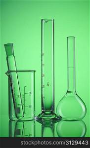 Chemical flasks over green background