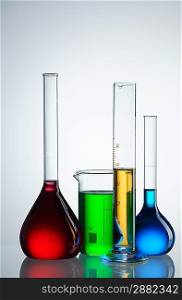 Chemical flasks with reagents over white