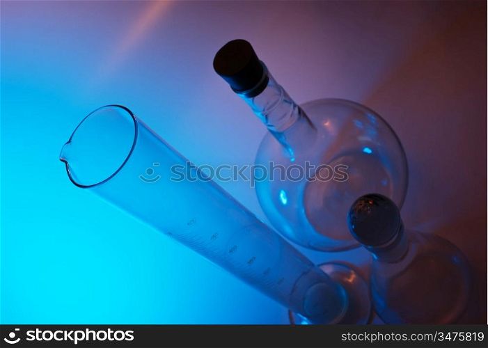 chemical glassware in multicolored lights
