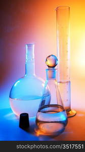 chemical glassware in multicolored lights