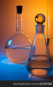 chemical glassware in multicolored lights