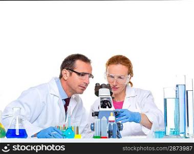 chemical laboratory with two scientist working with test tubes and microscope
