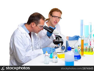 chemical laboratory with two scientist working with test tubes and microscope