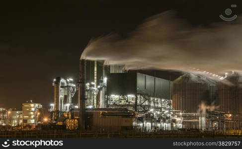 chemical oil refinery in the night with lot of smoke