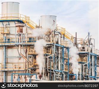 Chemical plant of a factory. Smokestacks ,pipes and tank.