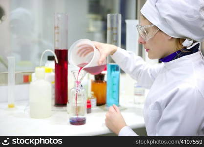 Chemical research laboratory, woman working, glass cylinder vase