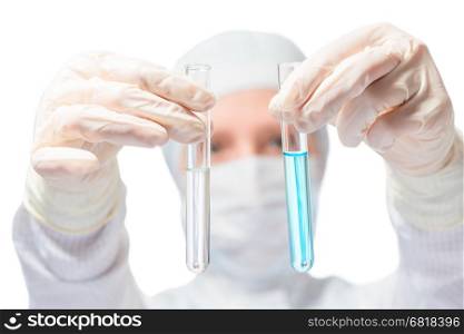 chemist, biologist, holding in front of two test tubes with liquid substances, focus on test tube