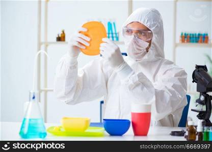 Chemist checking and testing plastic dishes