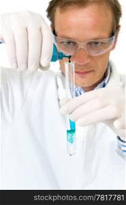 Chemist, diluting a blue substance in a test tube