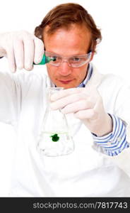 Chemist, diluting a green substance in a measuring beaker