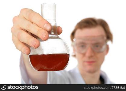 Chemist holds flask with brown liquid