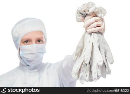 chemist in protective suit with a bunch of rubber gloves on a white background