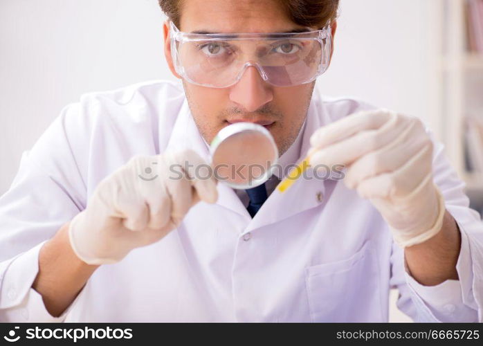 Chemist in the lab checking with ph strips