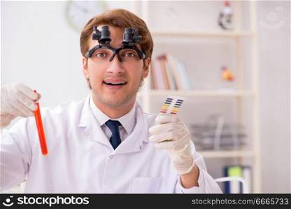 Chemist in the lab checking with ph strips. The chemist in the lab checking with ph strips