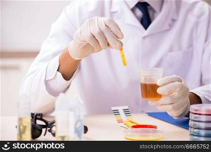 Chemist in the lab checking with ph strips. The chemist in the lab checking with ph strips