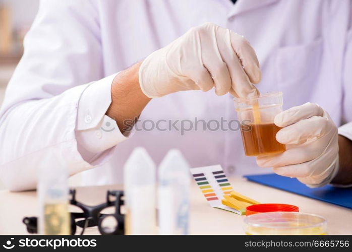 Chemist in the lab checking with ph strips