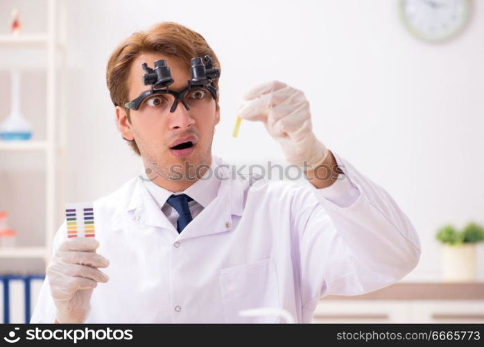 Chemist in the lab checking with ph strips