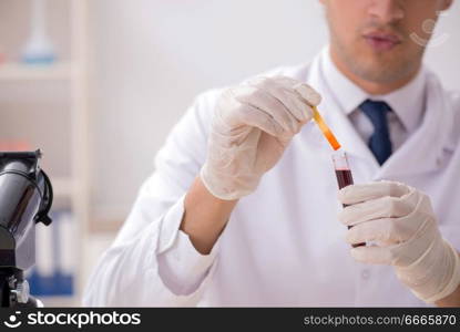 Chemist in the lab checking with ph strips. The chemist in the lab checking with ph strips