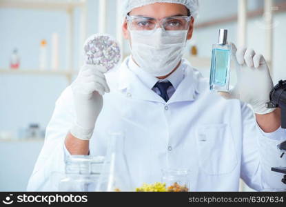 Chemist mixing perfumes in the lab