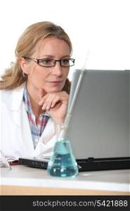 Chemist working at a laptop computer