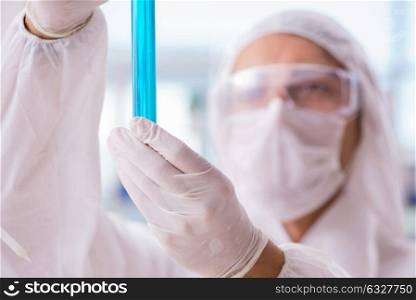 Chemist working in the laboratory with hazardous chemicals. The chemist working in the laboratory with hazardous chemicals