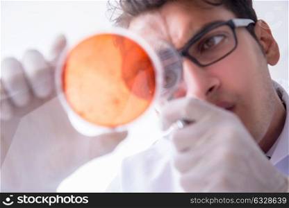 Chemist working in the laboratory with hazardous chemicals . The chemist working in the laboratory with hazardous chemicals