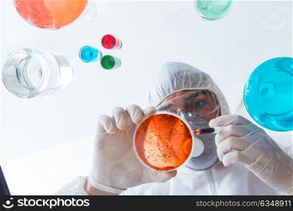 Chemist working in the laboratory with hazardous chemicals . The chemist working in the laboratory with hazardous chemicals