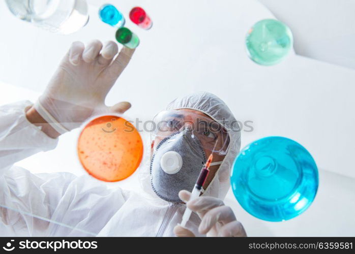 Chemist working in the laboratory with hazardous chemicals . The chemist working in the laboratory with hazardous chemicals