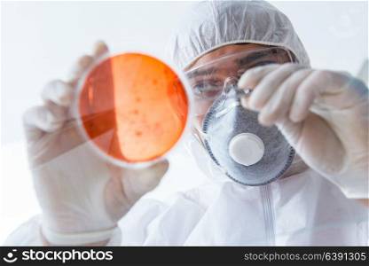 Chemist working in the laboratory with hazardous chemicals