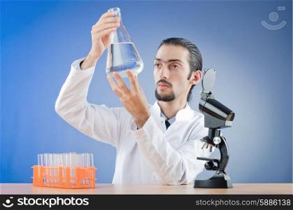 Chemist working with microscope
