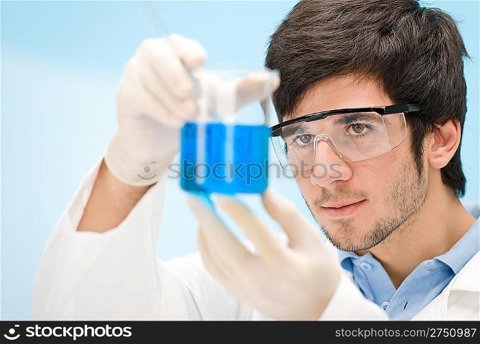 Chemistry experiment - scientist in laboratory, wear protective eyewear