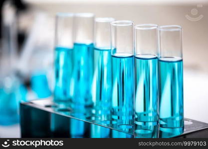 Chemistry laboratory glassware, science laboratory research and development concept, flask, beaker, and test tubes with blue liquid water s&le test, scientific test tubes equipment