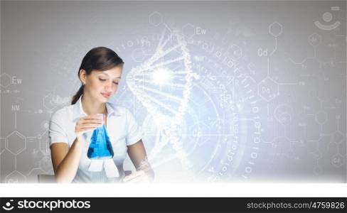 Chemistry lesson. Young woman doing tests at chemistry laboratory