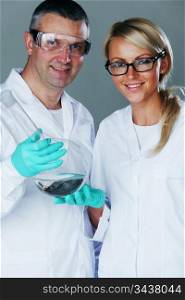 Chemistry researchers holding a secret green chemical substance