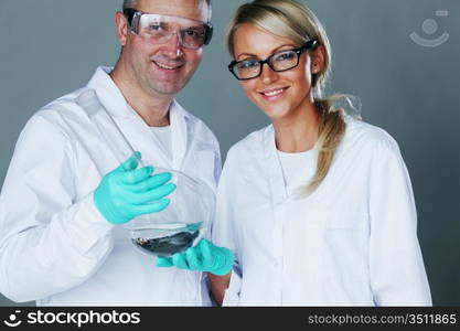 Chemistry researchers holding a secret green chemical substance