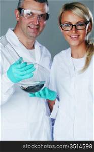 Chemistry researchers holding a secret green chemical substance