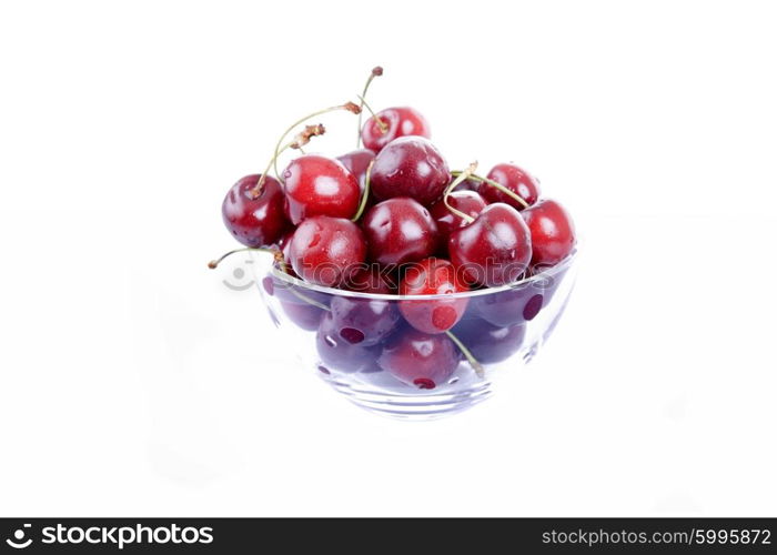 cherries on glass cup isolated on white background