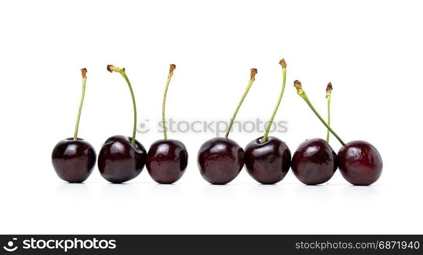cherry arranged in a row isolated on white