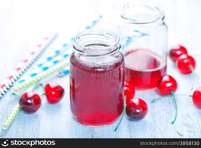 cherry drink in glass and on a table
