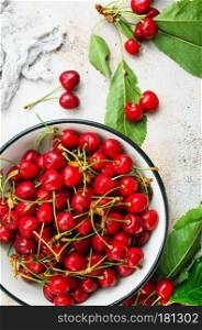 cherry in white bowl  on a table