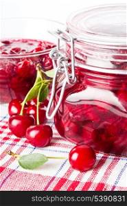Cherry jam with fresh fruits on white
