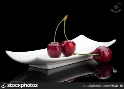 cherry on a plate. cherry on black background