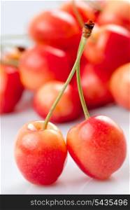 Cherry on white with fruit background