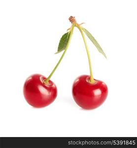 Cherry pair with green leaves isolated on white