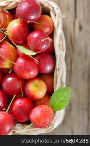 cherry-plum in basket on wooden background&#xA;&#xA;