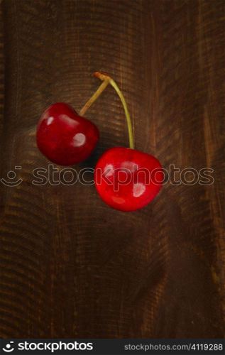 Cherry red fruits over dark wooden