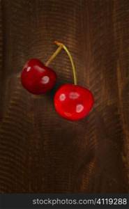 Cherry red fruits over dark wooden
