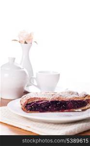 Cherry strudel with white dishes closeup