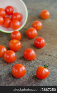 cherry tomato. Red cherry tomatoes on a textured wooden background